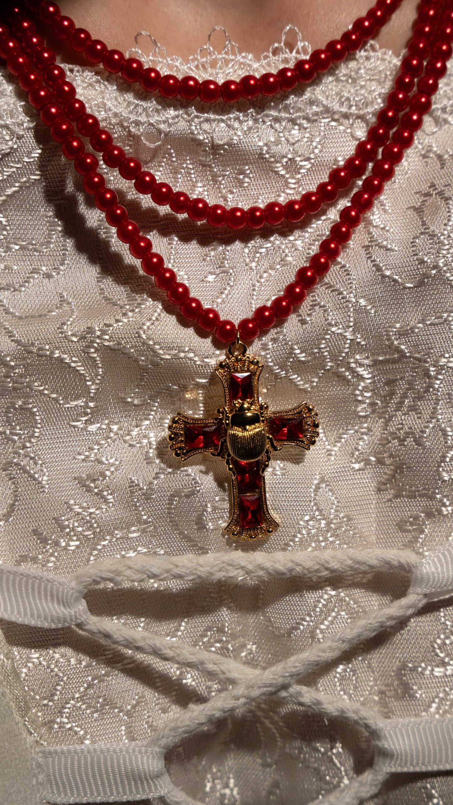 Elizabeth’s three layer red beaded scarab cross necklace