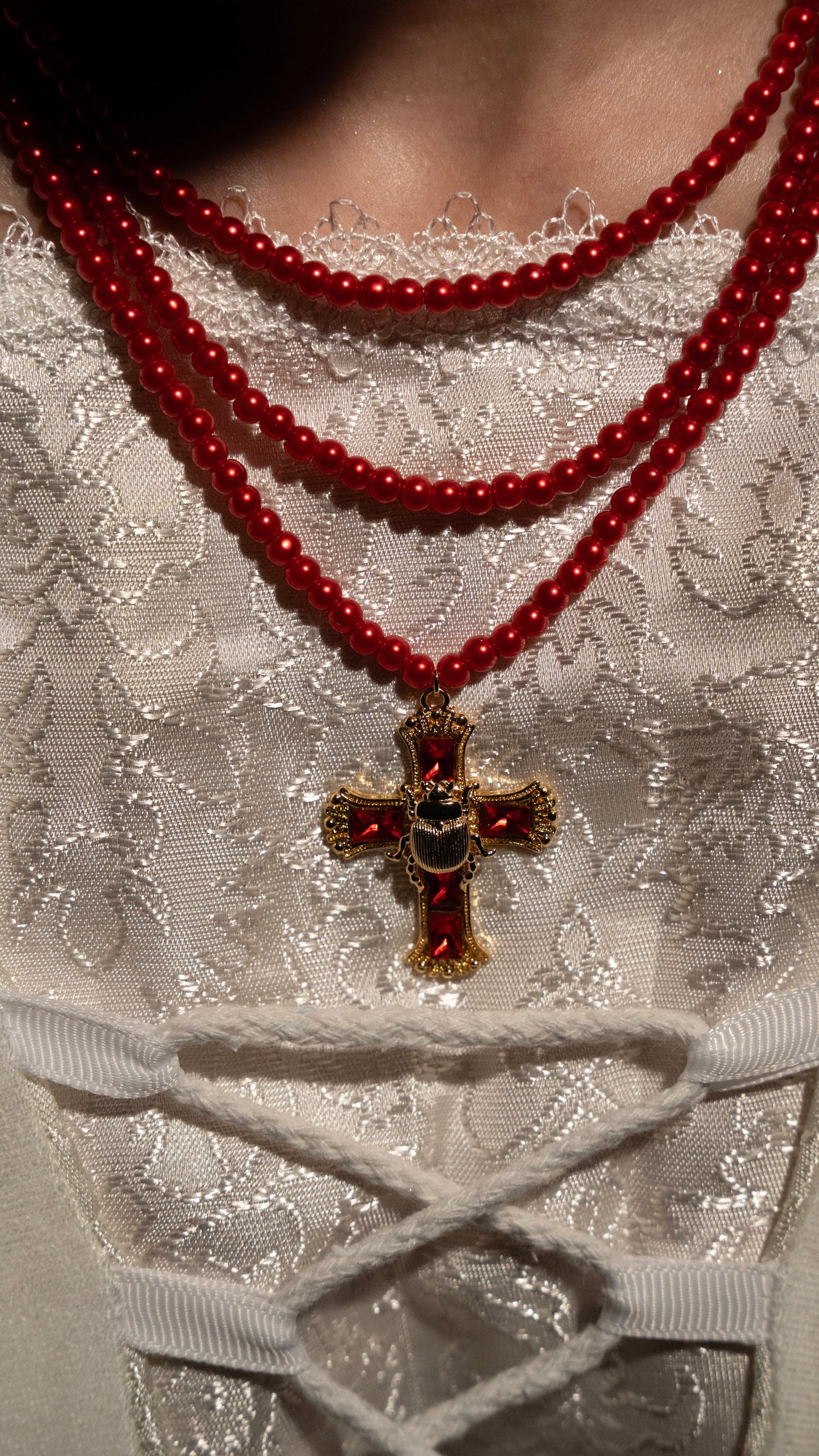 Elizabeth’s three layer red beaded scarab cross necklace